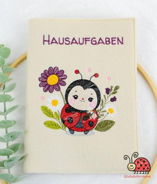 Huelle fuers Hausaufgabenheft Marienkaefer personalisiert